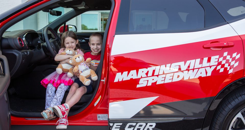 Carilion pediatrics physician Christopher Pierce, MD, and Martinsville Speedway President Clay Campbell present stuffed bears and other toys to young patients at Carilion Children's Tanglewood on Monday, Sept. 9, 2024, in Roanoke, Virginia.
